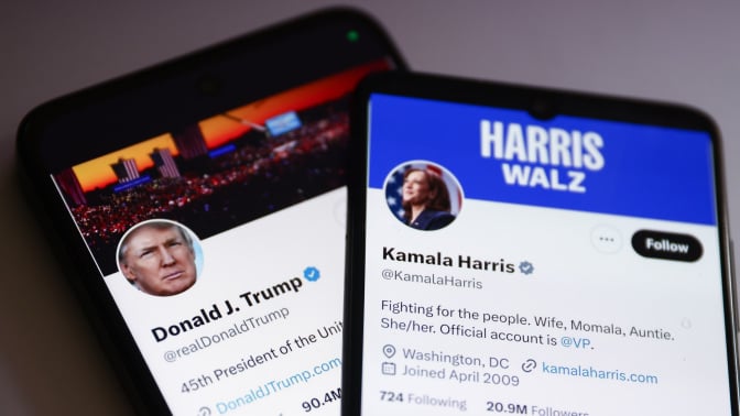 Two phones display the X/Twitter accounts of presidential candidates Donald Trump and Kamala Harris.