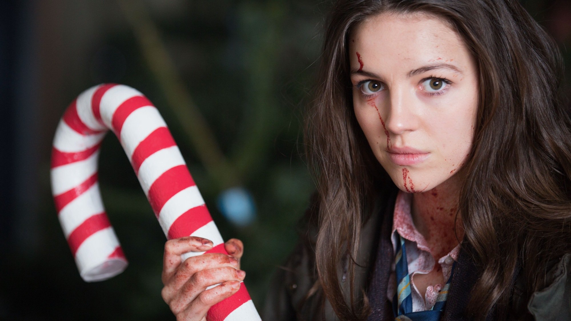 A teen girl poses with a giant candy cane in "Anna and the Apocalypse."