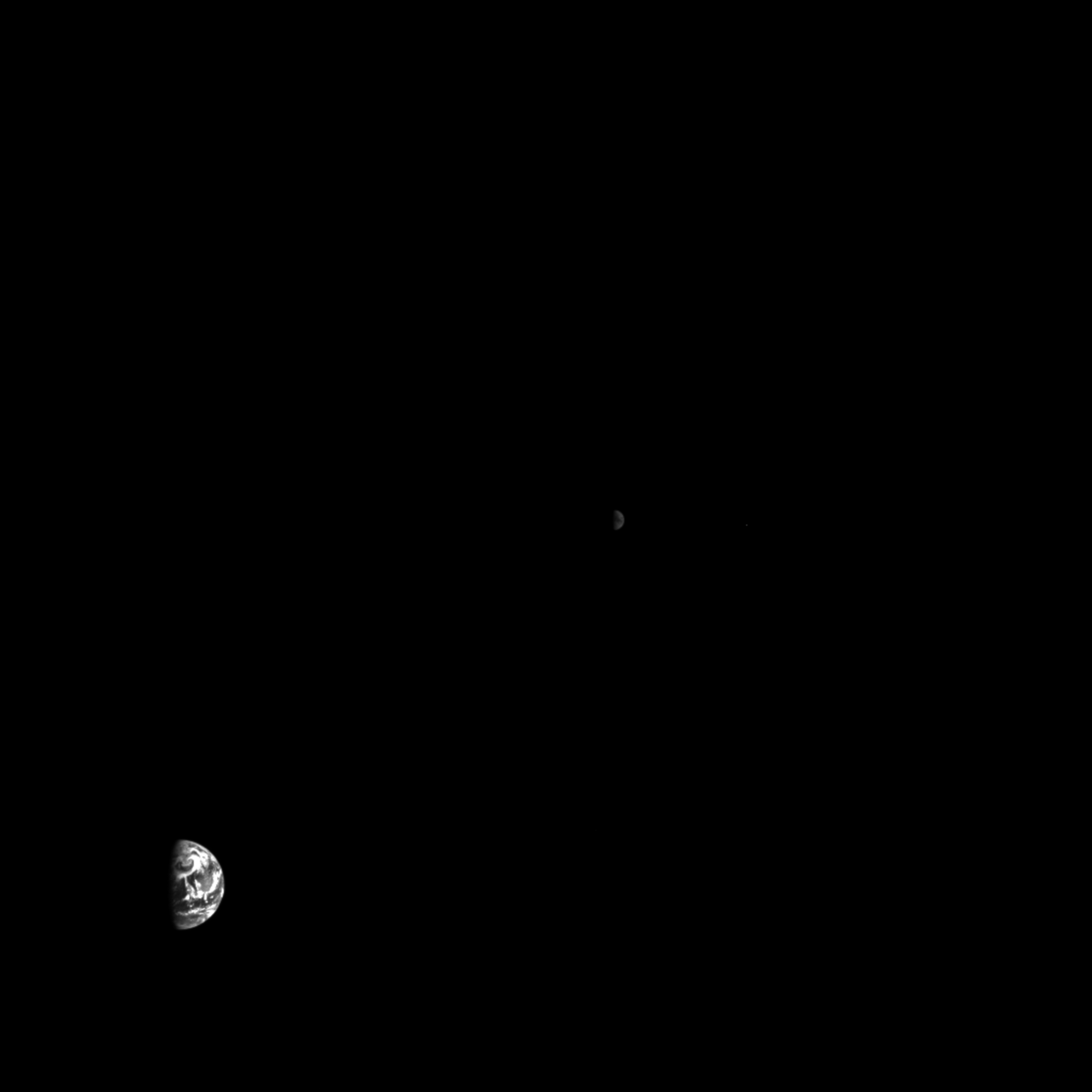 Earth (bottom left) and the moon (center) viewed from about 1 million miles away.