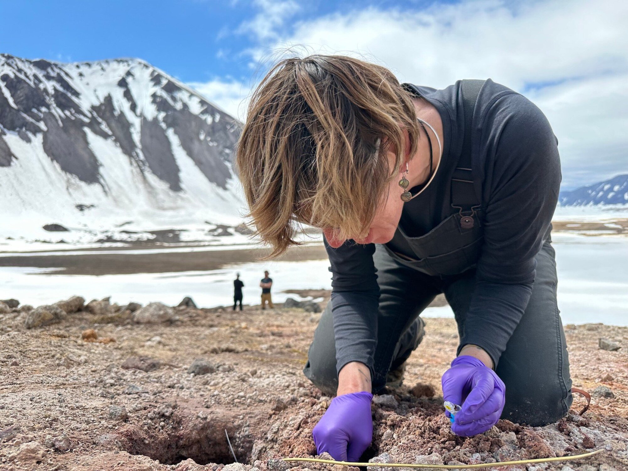 On the recent trip to the Valley of Ten Thousand Smokes, Heather Graham looks for evidence of past microbes that potentially lived around a fumarole.