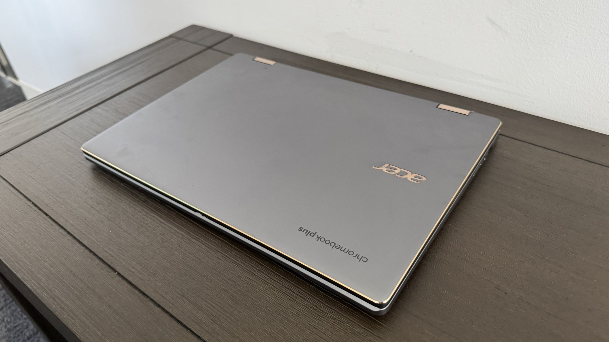 A closed Acer Chromebook Plus Spin 714 laptop on a wooden bench