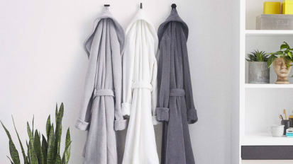 A Brooklinen Super-Plush Robe hanging in a bathroom.