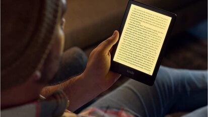 A person holding a new Kindle Paperwhite.