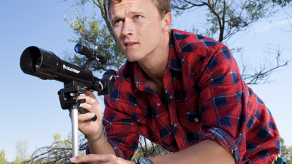 Person using a telescope from Celestron.