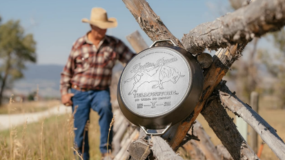 yellowstone lodge skillet in a field with cowboy in foreground