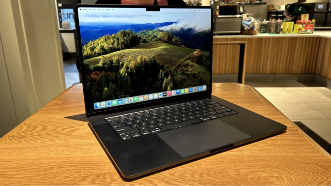 a 15-inch m3 apple macbook air sitting on a wooden table in starbucks