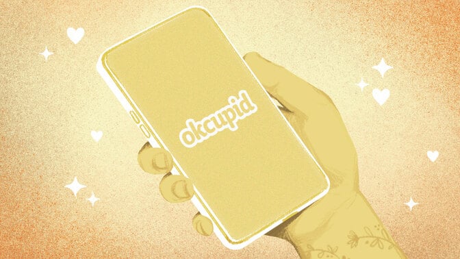 A drawn hand holding a phone with the okcupid logo